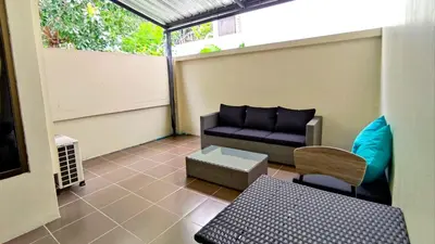 a living room with a couch and a table at Lucky Buako Hotel Patong in Patong Beach