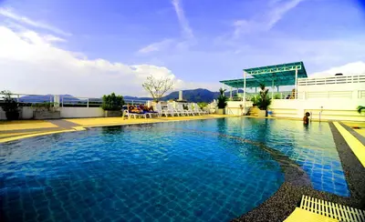 a large swimming pool in front of a building at Arita Hotel Patong in Patong Beach