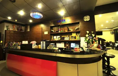 a bar in a restaurant with a clock on the wall at Arita Hotel Patong in Patong Beach