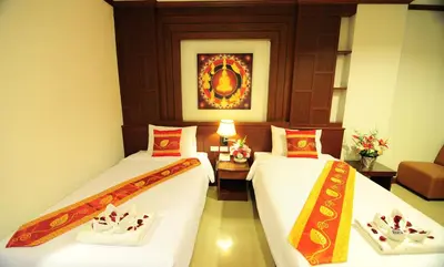 two beds in a hotel room with at Arita Hotel Patong in Patong Beach