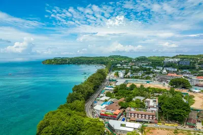 an aerial view of a town next to the ocean at Phuket Meet Holiday Hotel-Rawai \u666e\u5409\u5c9b\u76f8\u9047\u82b1\u56ed\u5ea6\u5047\u9152\u5e97-\u62c9\u5a01\u5e97 in Rawai Beach
