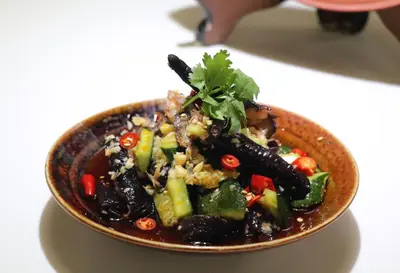 a bowl of food with vegetables in it on a table at Phuket Meet Holiday Hotel-Rawai \u666e\u5409\u5c9b\u76f8\u9047\u82b1\u56ed\u5ea6\u5047\u9152\u5e97-\u62c9\u5a01\u5e97 in Rawai Beach