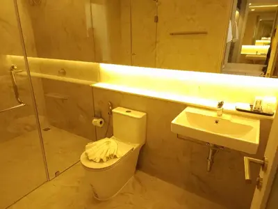 a bathroom with a toilet and a sink and a shower at Kamala Regent Residence in Kamala Beach