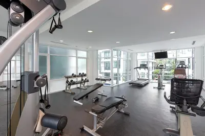 a gym with treadmills and machines in a building at Kamala Regent Residence in Kamala Beach