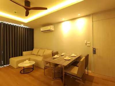 a living room with a table and a couch at Kamala Regent Residence in Kamala Beach