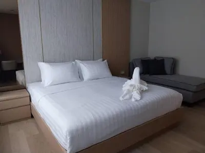a white bed with a towel on top of it at The Regent Residence Kamala in Kamala Beach