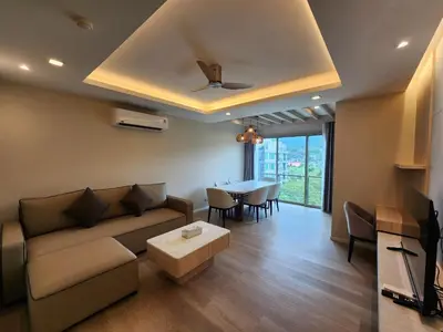 a living room with a couch and a table at The Regent Residence Kamala in Kamala Beach