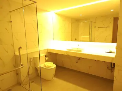 a bathroom with a sink and a toilet and a mirror at The Regent Residence Kamala in Kamala Beach