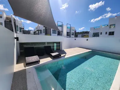 a swimming pool on the roof of a building at The Regent Residence Kamala in Kamala Beach