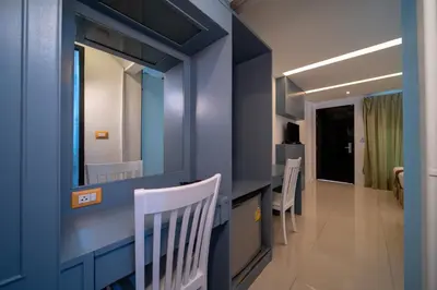 a blue bathroom with a counter and a mirror at Blue Carina Hotel Phuket in Phuket Town