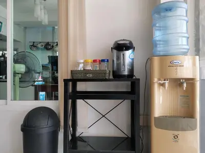 a room with a table with a water cooler and a box at Le Desir Resortel in Chalong