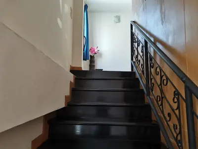 a stairway with a flower in a vase at Le Desir Resortel in Chalong