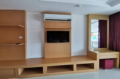 a living room with a flat screen tv in a room at Le Desir Resortel in Chalong