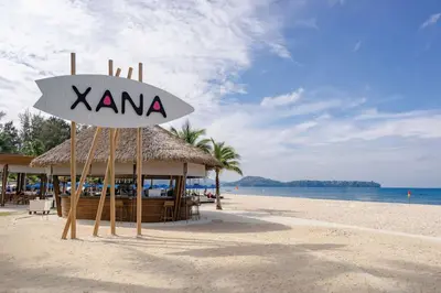 a restaurant on the beach with a sign on it at Angsana Laguna Phuket in Bang Tao Beach