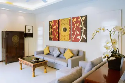 a living room with a couch and a coffee table at One Bedroom Oriental Villa Nai Harn in Nai Harn Beach