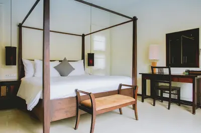 a bedroom with a four poster bed and a desk at One Bedroom Oriental Villa Nai Harn in Nai Harn Beach