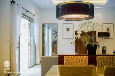 a dining room with a table and a pendant light at One Bedroom Oriental Villa Nai Harn in Nai Harn Beach