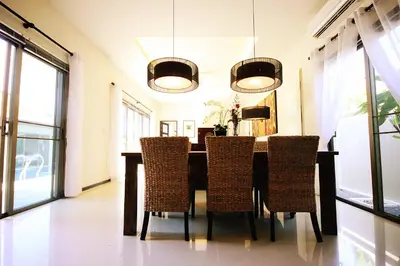 a dining room with a table and chairs at Two Bedroom Oriental Villa Nai Harn in Nai Harn Beach