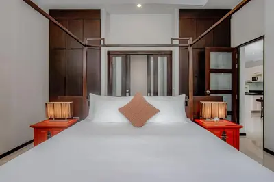 a bedroom with a large bed with two lamps at ONYX Villa Naiharn - 1 Bedroom with private pool in Nai Harn Beach