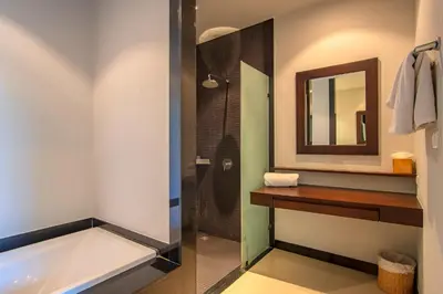 a bathroom with a bath tub and a mirror at ONYX Villa Naiharn - 1 Bedroom with private pool in Nai Harn Beach