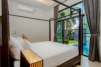 a bedroom with a bed and a large window at ONYX Villa Naiharn - 2 Bedrooms with private pool in Nai Harn Beach