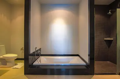 a bathroom with a bath tub and a toilet at ONYX Villa Naiharn - 2 Bedrooms with private pool in Nai Harn Beach