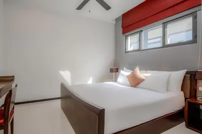 a bedroom with a large white bed with a window at ONYX Villa Naiharn - 2 Bedrooms with private pool in Nai Harn Beach