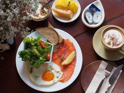 a plate of food with an egg and vegetables on a table at ONYX Villa Naiharn - 3 Bedrooms with private pool in Nai Harn Beach