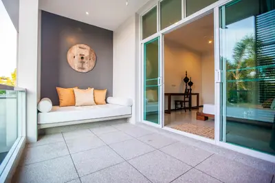 a living room with a couch on a porch at Villa 1 Bedroom with private pool at Oxygen Bangtao in Bang Tao Beach