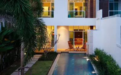 a swimming pool in the backyard of a house at night at Villa 2 Bedrooms with private pool at Oxygen Bangtao in Bang Tao Beach