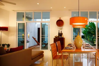 a living room with a dining table and a couch at Villa 2 Bedrooms with private pool at Oxygen Bangtao in Bang Tao Beach