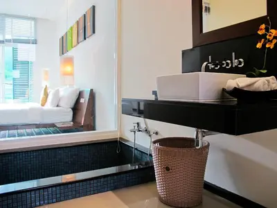 a bathroom with a sink and a bed in a mirror at Villa 2 Bedrooms with private pool at Oxygen Bangtao in Bang Tao Beach