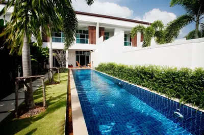 a swimming pool in front of a house at Villa 2 Bedrooms with private pool at Oxygen Bangtao in Bang Tao Beach