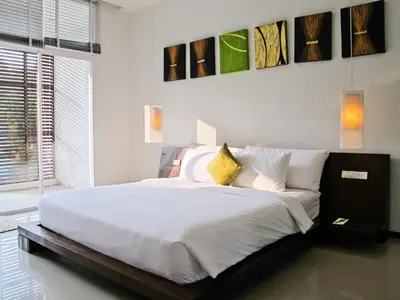 a bedroom with a large bed with white sheets at Villa 2 Bedrooms with private pool at Oxygen Bangtao in Bang Tao Beach