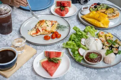 a table with plates of food on it at Villa 3 Bedrooms with private pool at Oxygen Bangtao in Bang Tao Beach