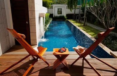 two chairs and a table next to a swimming pool at Villa 4 Bedrooms with private pool at Oxygen Bangtao in Bang Tao Beach