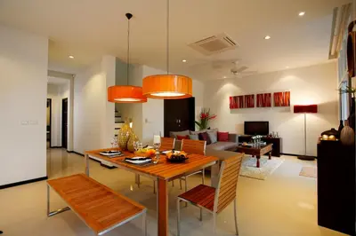 a dining room and living room with a table and chairs at Villa 4 Bedrooms with private pool at Oxygen Bangtao in Bang Tao Beach