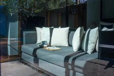 a couch with pillows and a plate on it at Villa 1 Bedroom with private pool at Wings Pasak in Bang Tao Beach