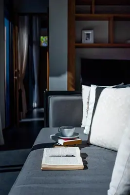 a book on a bed with a bowl and aucer gmaxwell gmaxwell gmaxwell at Villa 1 Bedroom with private pool at Wings Pasak in Bang Tao Beach