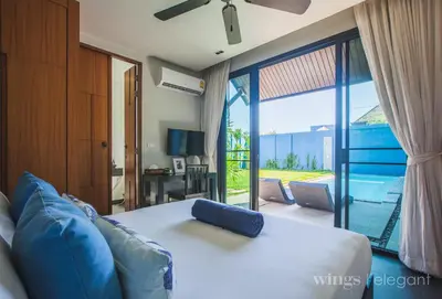 a bedroom with a bed and a view of a patio at Villa 2 Bedrooms with private pool at Wings Pasak in Bang Tao Beach