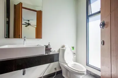 a bathroom with a sink and a toilet and a mirror at Villa 2 Bedrooms with private pool at Wings Pasak in Bang Tao Beach