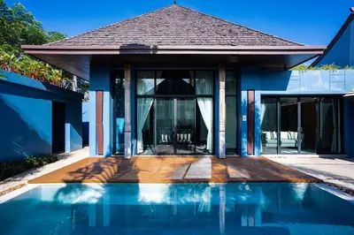 a house with a swimming pool in front of a house at Villa 2 Bedrooms with private pool at Wings Pasak in Bang Tao Beach