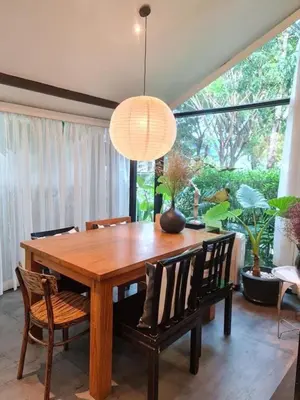 a dining room with a wooden table and chairs at Villa 2 Bedrooms with private pool at Wings Pasak in Bang Tao Beach