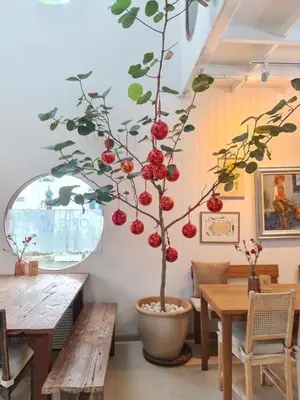 a tree in a room with benches and a table at Villa 3 Bedrooms with private pool at Wings Pasak in Bang Tao Beach