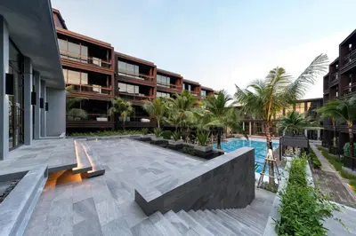 a courtyard of a building with a swimming pool at Saturdays Residence - 1 Bedroom Service Apartment in Rawai Beach