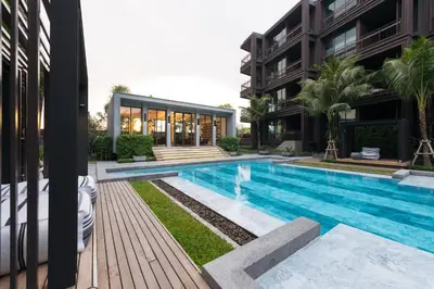 a swimming pool in front of a building at Saturdays Residence - 1 Bedroom Service Apartment in Rawai Beach