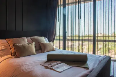 a bedroom with a bed with a laptop on it at Saturdays Residence - 1 Bedroom Service Apartment in Rawai Beach