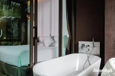 a bathroom with a white sink and a bed at Saturdays Residence - 2 Bedrooms Service Apartment in Rawai Beach