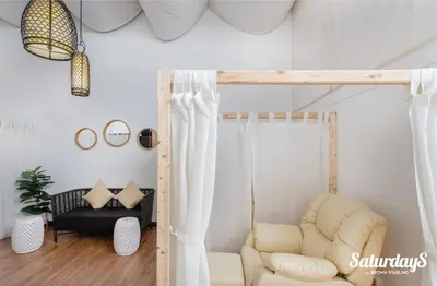 a living room with a loft bed and a chair at Saturdays Residence - 2 Bedrooms Service Apartment in Rawai Beach