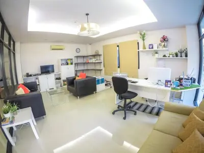 a living room with a desk and a couch at Hiran Residence in Patong Beach